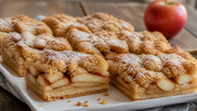 Freshly baked Apple Kuchen Bars with streusel topping on a ceramic plate