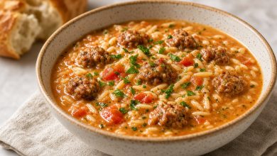 Bowl of Marry Me Sausage Orzo Soup with sausage, orzo, tomatoes, and herbs