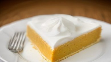 No-bake pumpkin pie slice with whipped cream on a white plate.