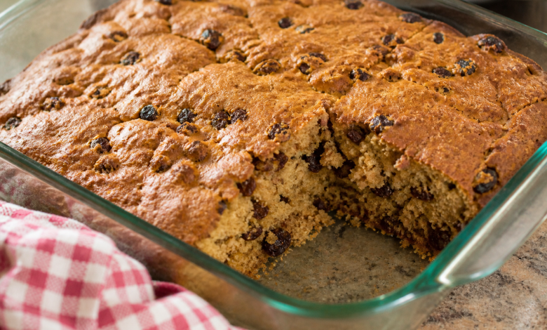Old-Fashioned War-Time Cake with raisins cut into squares in a glass baking dish