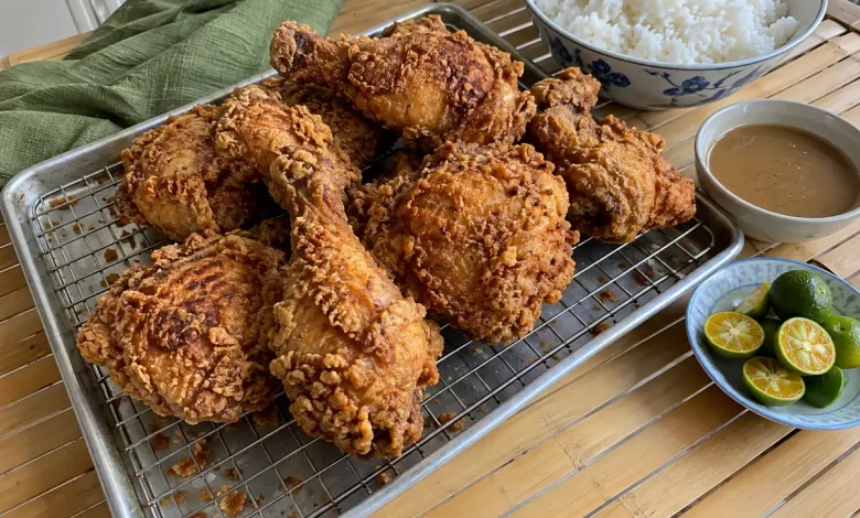 Filipino-style crispy fried chicken thighs and drumsticks with a golden craggy crust on a wire rack