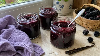 Jars of French-style blackberry vanilla jam with fresh blackberries and a vanilla bean