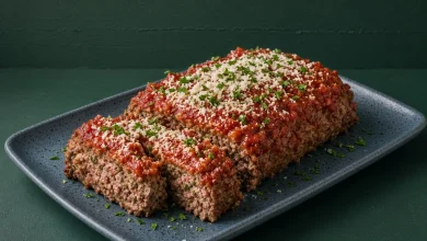 Italian meatloaf with tomato sauce, Parmesan and parsley sliced on a blue stoneware platter