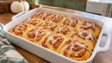 Pumpkin cream cheese crescent rolls with cream cheese glaze in a baking dish